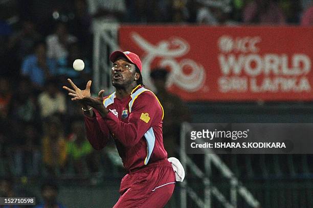 West Indies cricketer Chris Gayle takes a catch to dismiss Ireland cricketer Paul Stirling during the ICC Twenty20 Cricket World Cup match between...