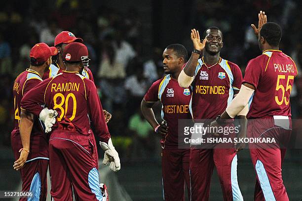 West Indies cricketer Darren Sammy celebrates after he dismissed Ireland cricketer Paul Stirling during the ICC Twenty20 Cricket World Cup match...
