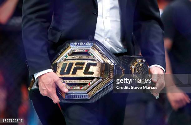 The UFC featherweight title belt is carried by UFC president Dana White after the fight between UFC featherweight champion Alexander Volkanovski and...