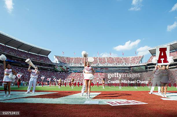 Cheerleaders with The Alabama Crimson Tide waves to the crowd while playing against the Florida Atlantic Owls on September 22, 2012 at Bryant-Denny...