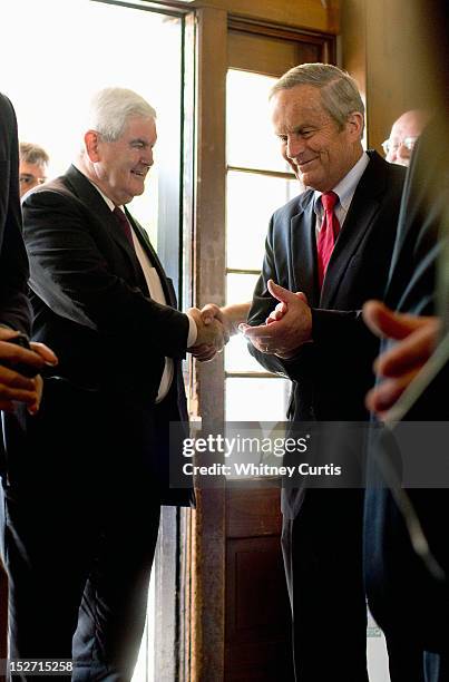 Former Speaker of the House Newt Gingrich and U.S. Rep. Todd Akin greet supporters as they enter a press conference on September 24, 2012 in...