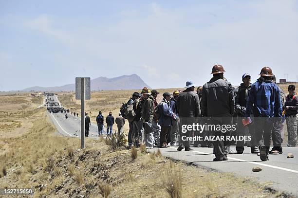 Bolivian miners associated in cooperatives block the road that leads to the border with Peru near Santa Ana, 90 km from La Paz, on September 24, 2012...