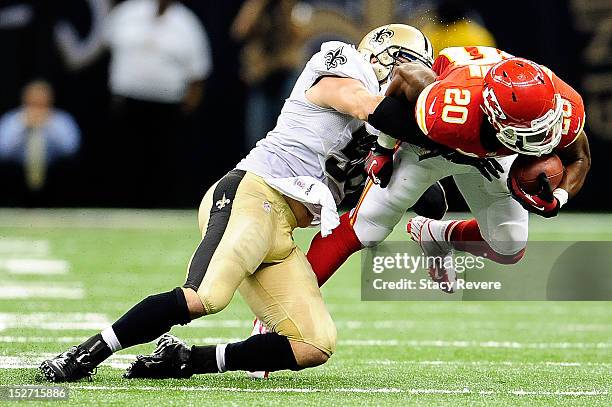 Shaun Draughn of the Kansas City Chiefs is brought down by Scott Shanle of the New Orleans Saints during a game at the Mercedes-Benz Superdome on...