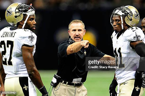 Malcolm Jenkins, Roman Harper and defensive coordinator Steve Spagnuolo of the New Orleans Saints discuss a play during a game against the Kansas...