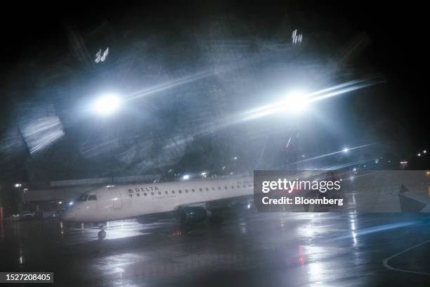 Delta plane on the tarmac during a rain storm at Boston Logan Airport in Boston, Massachusetts, US, on Friday, June 2, 2023. Delta Air Lines Inc. Is...