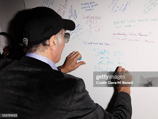 Beach Boy David Marks signs the wall at the EMI Music Sound Foundation fundraiser at Somerset House on September 24, 2012 in London, England.