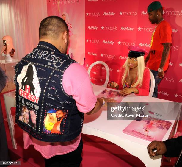 Nicki Minaj signs autographs for fans at her "Pink Friday" fragrance launch at Macy's Herald Square on September 24, 2012 in New York City.