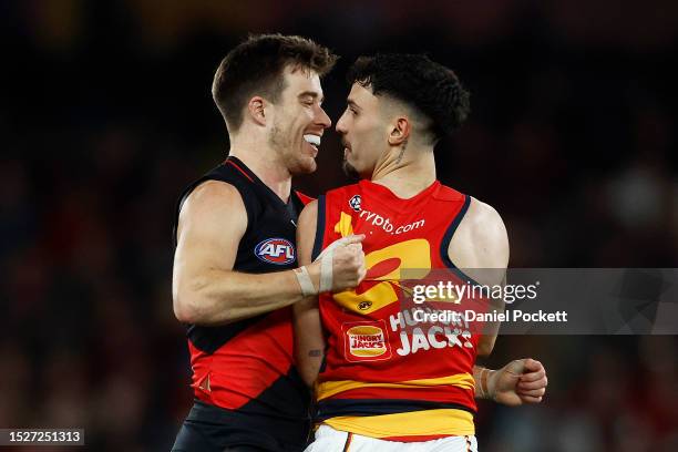 Zach Merrett of the Bombers reacts with Izak Rankine of the Crows after a tackle resulting in dropping the ball during the round 17 AFL match between...