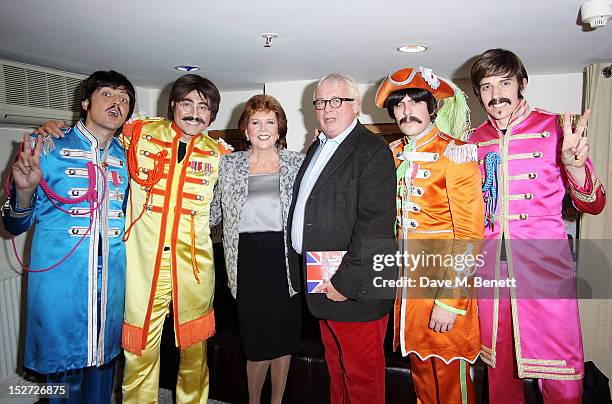 Cilla Black and Christopher Biggins pose with cast members Ian Garcia, Reuven Gershon, Stephen Hill and Phil Martin at the interval during the press...