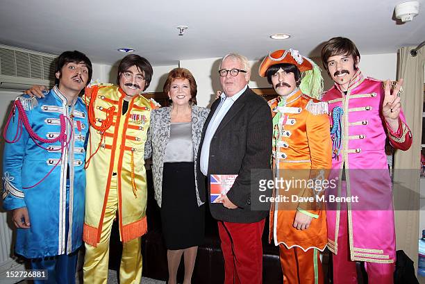 Cilla Black and Christopher Biggins pose with cast members Ian Garcia, Reuven Gershon, Stephen Hill and Phil Martin at the interval during the press...