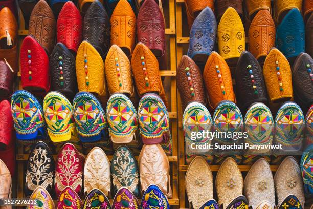 multi colored morocco shoe "babouche" leather shoes in moroccan style, souvenirs in souk / market in medina - rabat shoes stock pictures, royalty-free photos & images