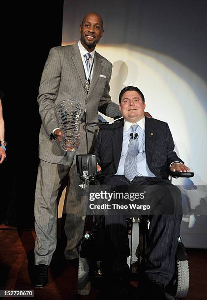 Former NBA basketball player Alonzo Mourning and former NFL football player Marc Buoniconti pose onstage at the 27th Annual Great Sports Legends...