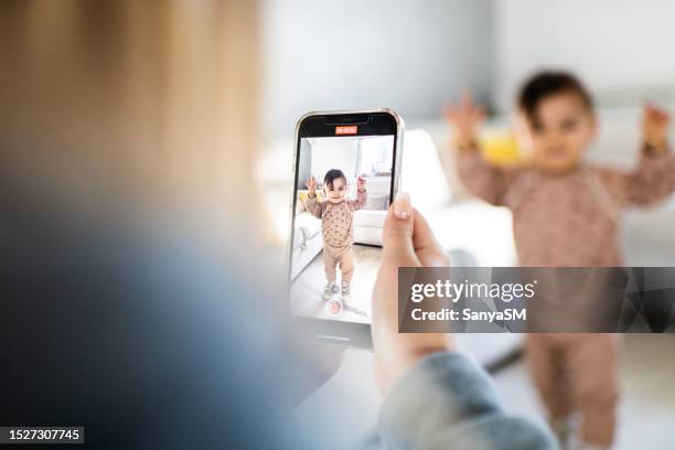 first steps of my baby - mms stock pictures, royalty-free photos & images