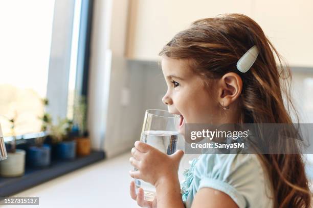 beautiful girl drinking water - children drinking water stock pictures, royalty-free photos & images
