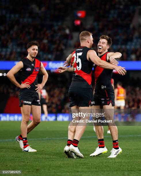 Jake Stringer of the Bombers celebrates with Zach Merrett of the Bombers after kicking a goal during the round 17 AFL match between Essendon Bombers...
