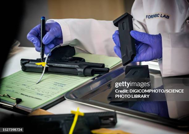 forensic analysis of handgun - forensic science technician stock pictures, royalty-free photos & images