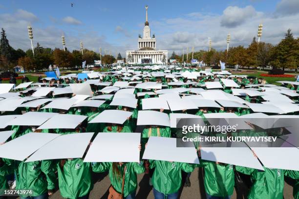 Volunteers take part in flash mob to mark the 500-days before Sochi 2014 Winter Olympics at the VVTs a public park and exhibition space in Moscow, on...