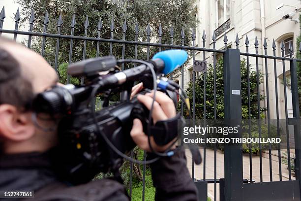 Cameraman grabs pictures of the headquarters of the Wendel Investment group on September 25, 2012 in Paris. The headquarters of the Wendel Investment...