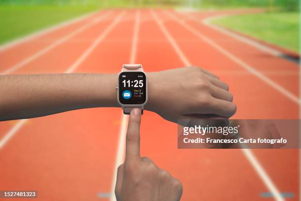 female runner checking health status on her smart watch - smart watch on wrist stock pictures, royalty-free photos & images