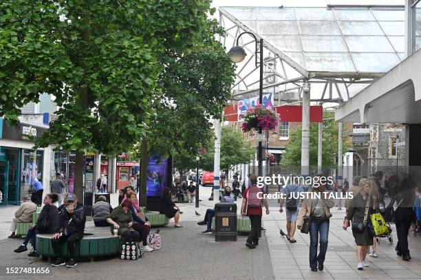 People make their way along the High Street in Uxbridge, west London on July 11, 2023. In the Conservative stronghold of Uxbridge, west London, many...