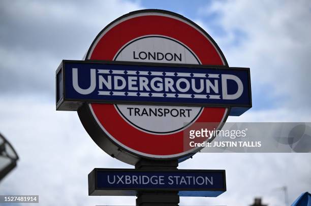 Sign for Uxbridge Underground Station is pictured on the High Street in Uxbridge, west London on July 11, 2023. In the Conservative stronghold of...