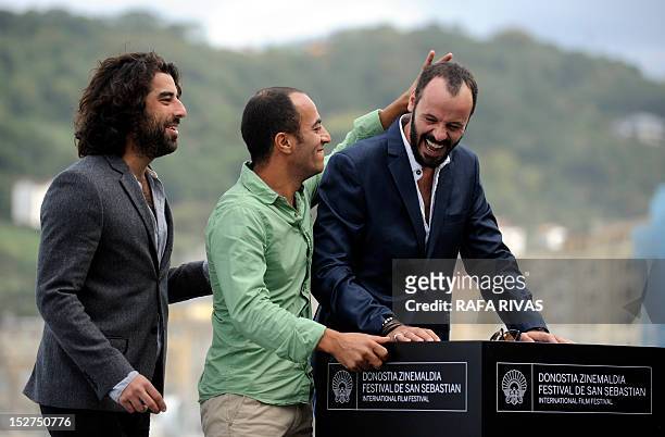 French actor Karim Saleh and Palestinian actors Ali Suliman and Ramzi Maqdisi pose during a photocall after the screening of the film "The Attack" by...