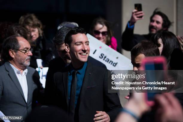 David Daleiden, center, of California, who has been charged with tampering with a governmental record, a second-degree felony with a possible...