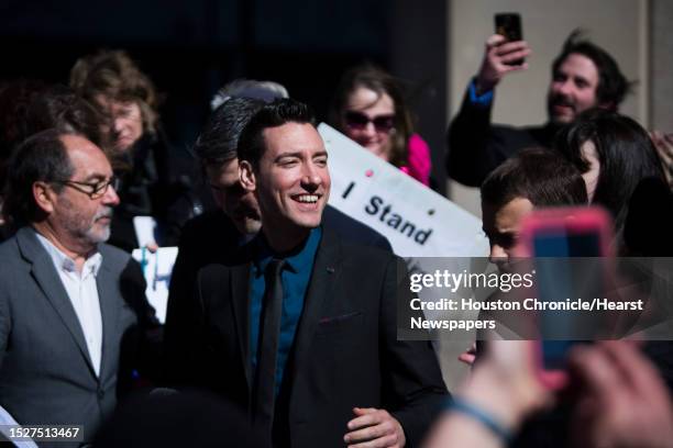 David Daleiden, center, of California, who has been charged with tampering with a governmental record, a second-degree felony with a possible...