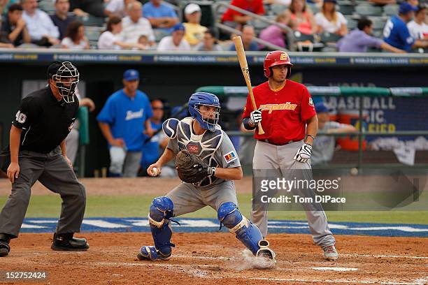 Charles Cutler of Team Israel stares the runner down at first base against Team Spain during game 6 of the Qualifying Round of the World Baseball...