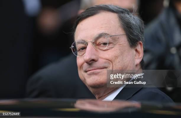 Mario Draghi, president of the European Central Bank , departs after speaking at a conference of the German Federation of Industry on September 25,...