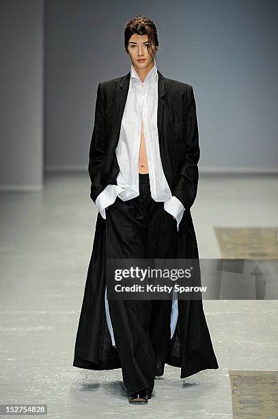 Model walks the runway during the Moon Young Hee Spring / Summer 2013 show as part of Paris Fashion Week at Garage Turenne on September 25, 2012 in...