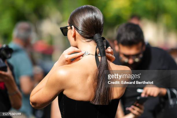 Guest wears black sunglasses, a diamonds large necklace, a black velvet shoulder-off / embroidered black fabric and white polka dots print pattern...