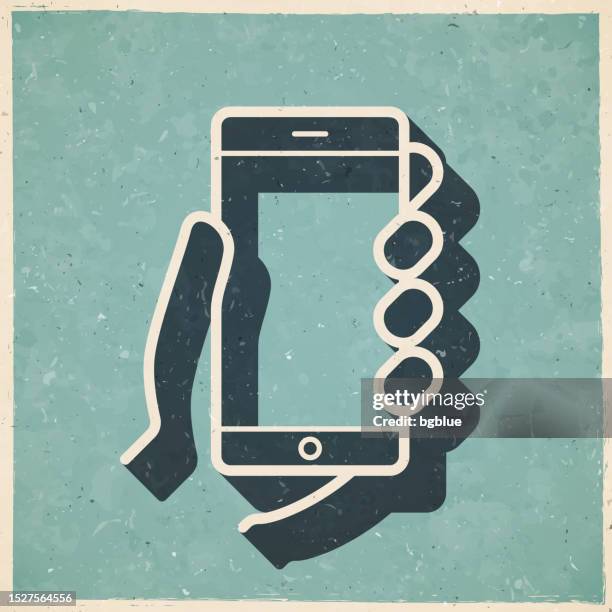 hands holding mobile phone. icon in retro vintage style - old textured paper - using tablet blank screen stock illustrations