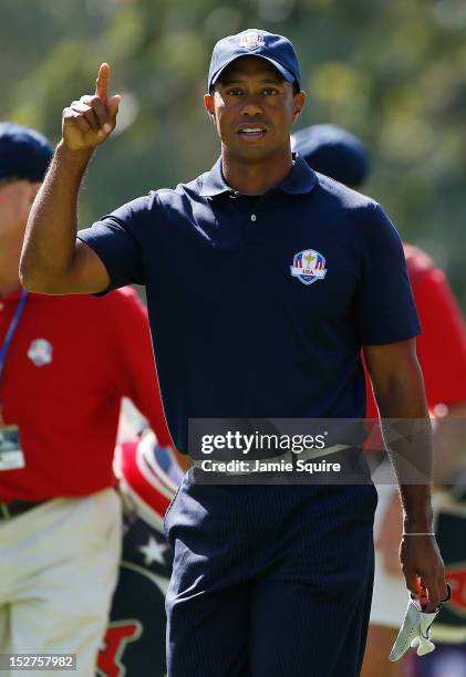 Tiger Woods of the USA walks off a tee in a practice round during the second preview day of The 39th Ryder Cup at Medinah Country Golf Club on...