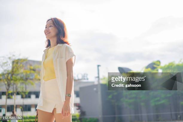 carefree young woman in city - bright future stock pictures, royalty-free photos & images