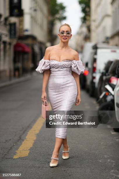 Guest wears rhinestones circle sunglasses, rhinestones earrings, a white and pale purple houndstooth print pattern shoulder-off / puffy short sleeves...