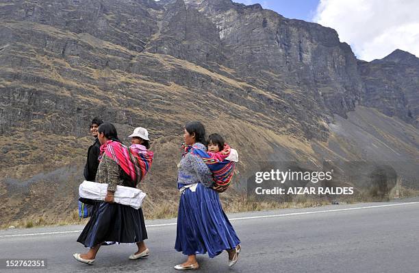 Indigenous women walk along a road linking La Paz with Las Yungas, near Pongo, 35 km northeast of La Paz, which was blocked by miners demanding the...