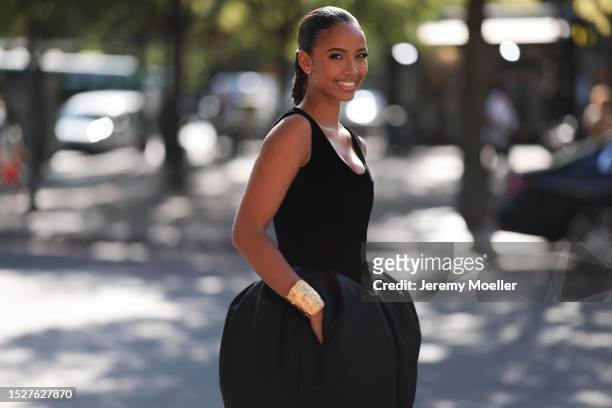 Flora Coquerel seen outside Ashi Studio show wearing black ballon dress, gold Schiaparelli bracelet and black sparkly plateau heels during the Haute...