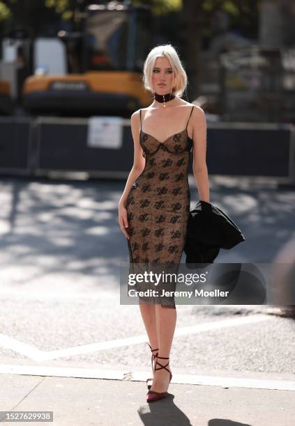 Lara Cosima Henckel von Donnersmarck seen outside Ashi Studio show wearing black chocker, brown and black slim dress with pattern on it and red heels...