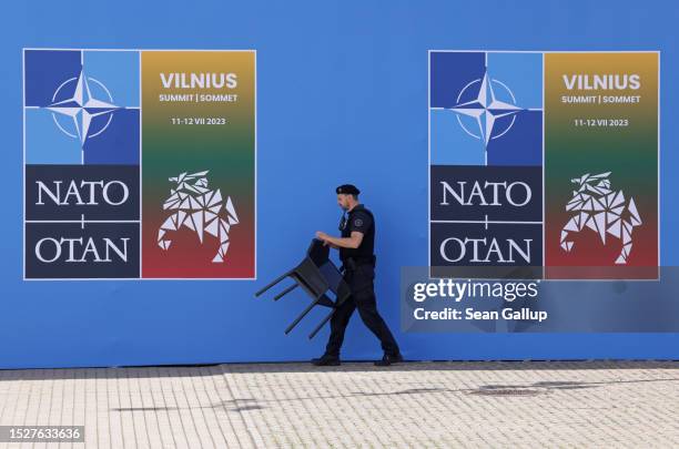 Security guard moves a chair at the NATO summit venue on July 09, 2023 in Vilnius, Lithuania. Vilnius is scheduled to host the July NATO Summit.