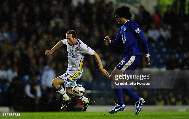 Leeds player Aidan White beats Everton player Marouane Fellaini to the ball during the Capital One Cup Third Round match between Leeds United and...