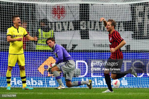 Stefan Aigner of Frankfurt celebrates his team's first goal as goalkeeper Roman Weidenfeller and Lukasz Piszczek of Dortmund react during the...