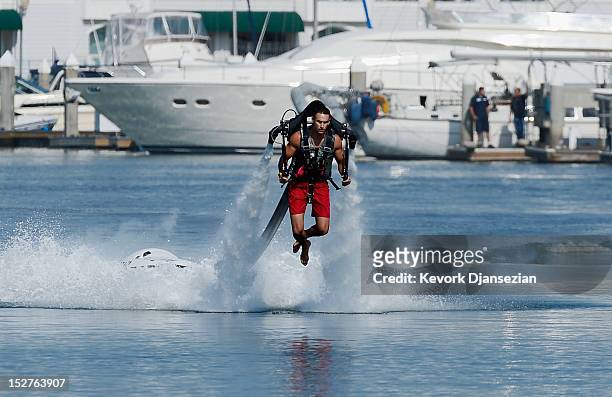 Dean O'Malley flies using a JetLev, a water-powered jetpack flying machine in the Newport Beach harbor on September 25, 2012 in Newport Beach,...