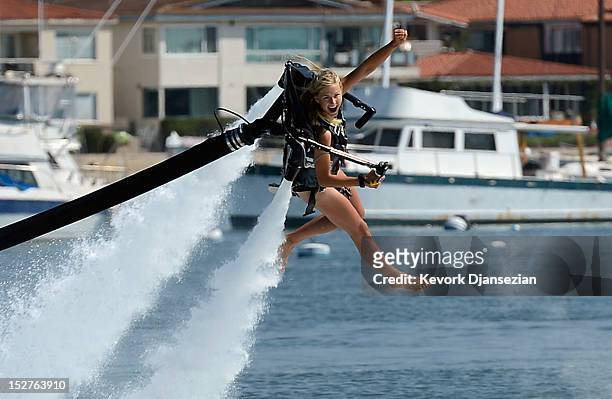 Johnnie Faye Carthwright a flight instructor assistant, demonstrates flying using a JetLev, a water-powered Jetpack flying machine in the Newport...