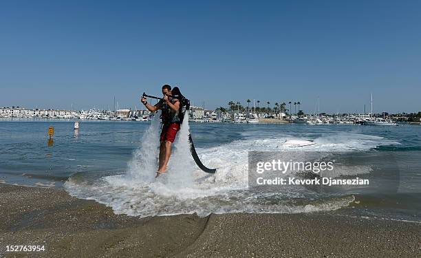 Dean O'Malley flies using a JetLev, a water-powered jetpack flying machine in the Newport Beach harbor on September 25, 2012 in Newport Beach,...