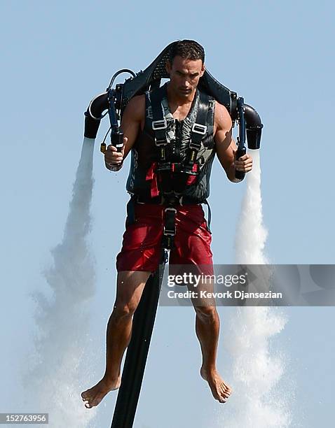 Dean O'Malley flies using a JetLev, a water-powered jetpack flying machine in the Newport Beach harbor on September 25, 2012 in Newport Beach,...