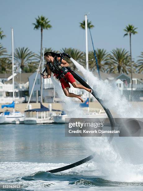 Dean O'Malley flies using a JetLev, a water-powered jetpack flying machine in the Newport Beach harbor on September 25, 2012 in Newport Beach,...