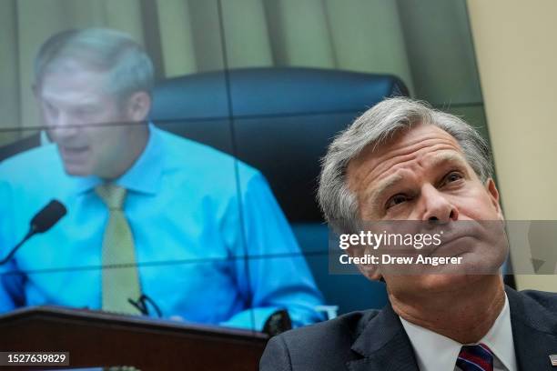 Director Christopher Wray listens to committee chairman Rep. Jim Jordan during a House Judiciary Committee about oversight of the Federal Bureau of...