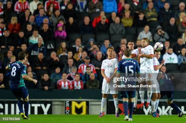 Craig Gardner of Sunderland scores the opening goal from a freekick during the Captial One Cup third round match between MK Dons and Sunderland at...