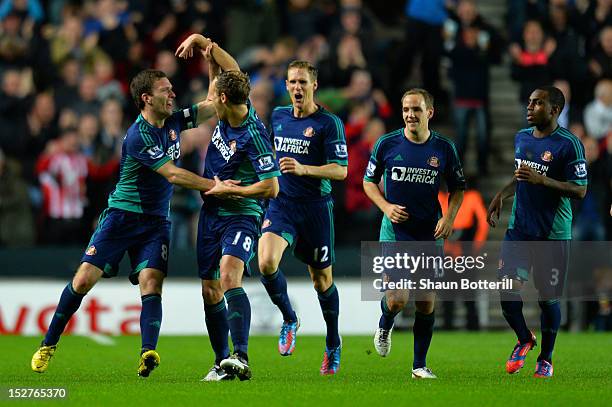 Craig Gardner of Sunderland celebrates scoring the first goal with David Meyler of Sunderland during the Captial One Cup third round match between MK...